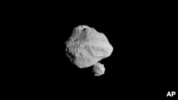 The U.S spacecraft Lucy made a close flyby of the asteroid Dinkinesh on Nov. 1, 2023. The tiny asteroid 300 million miles from earth has an even tinier sidekick moon, Lucy's photos revealed. (NASA via AP)