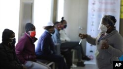 A medical worker addresses some of the first vaccine volunteers, at the Chris Hani Baragwanath hospital in Soweto, Johannesburg, June 24, 2020.