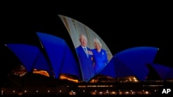 The Sydney Opera House sails show photos of Britain's King Charles and Queen Camilla soon after their arrival in Sydney, Oct. 18, 2024.