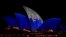 The Sydney Opera House sails show photos of Britain's King Charles and Queen Camilla soon after their arrival in Sydney, Oct. 18, 2024.