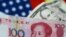 FILE - U.S. dollar and China yuan notes are seen in this illustration, June 2, 2017. This June, the yuan is set for its biggest monthly fall on record.