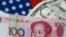 FILE - U.S. dollar and China yuan notes are seen in this illustration, June 2, 2017. This June, the yuan is set for its biggest monthly fall on record.
