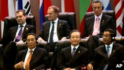 Russia's Prime Minister Dmitry Medvedev, top left, Poland's Prime Minister Donald Tusk, top center, Singapore's Prime Minister Lee Hsien Loong, top right, Laos' President Choummaly Sayasone, bottom left, China's Premier Wen Jiabao, bottom center, and Cambodia's Prime Minister Hun Sen take part in the opening ceremony for the ASEM Summit in Vientiane, Laos, Monday, Nov. 5, 2012. (AP Photo/Sakchai Lalit)