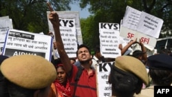 FILE - Indian activists and students hold placards and shout slogans during a protest against the alleged political silence over the rape of a child near Jammu and a rape case in Uttar Pradesh state, in New Delhi, April 12, 2018. 