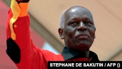 FILE: Angolan President Jose Eduardo dos Santos Angolan greets the crowd during his final election campaign rally in Kilamba Kaixi, on the outskirts of Luanda, on August 29, 2012. 