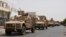 FILE - Yemeni pro-goverment forces fighting Houthi rebels are seen riding military vehicles on a street in the port city of Aden, Yemen, July 14, 2015. 