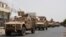 FILE - Yemeni pro-government forces fighting Houthi rebels are seen riding military vehicles on a street in the port city of Aden, Yemen, July 14, 2015. 