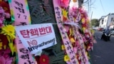 Wreaths sent by supporters of impeached South Korean President Yoon Suk Yeol are displayed outside the Constitutional Court in Seoul, South Korea, Friday, Dec. 27, 2024. (AP Photo/Ahn Young-joon)