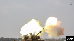 FILE - An Israeli self-propelled artillery howitzer fires a shell to bombard the Gaza Strip from the border area in southern Israel on December 12, 2023 amid ongoing battles with the Palestinian Hamas movement.