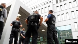 FILE - Police officers guard the surroundings of the Charite Mitte Hospital Complex, where Russian opposition leader Alexei Navalny is receiving medical treatment, in Berlin, Germany, Aug. 22, 2020. 