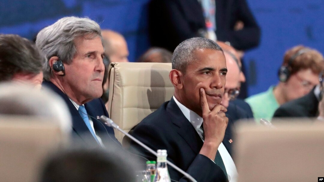 President Barack Obama waits next to State Secretary John Kerry for the start of the first working session of the North Atlantic Council at the NATO summit in Warsaw, Poland, Friday, July 8, 2016. 