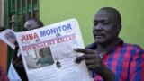 FILE - A man reads a copy of the Juba Monitor, with a heading referring to the killing of South Sudanese journalist Peter Moi of The New Nation newspaper, on August 21, 2015, in Juba.