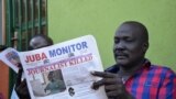 FILE - South Sudan's lawmaker Nhial Bol reads a copy of the Juba Monitor with a heading referring to the killing of South Sudanese journalist Peter Moi of The New Nation newspaper in Juba, Aug. 21, 2015 