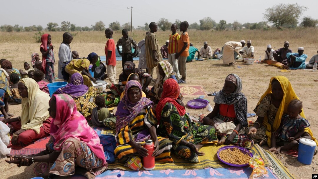 FILE - People displaced by Boko Haram wait to be screened at Furore camp in Yola, Nigeria, near the country's border with Cameroon, Dec. 8, 2015. Returnees to Cameroon have have been rejected by their communities. 
