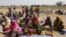 FILE - People displaced by Boko Haram wait to be screened at Furore camp in Yola, Nigeria, near the country's border with Cameroon, Dec. 8, 2015. Returnees to Cameroon have have been rejected by their communities. 