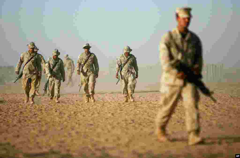 July 2009 -- U.S. Marines launch the first major offensive operation (Operation Khanjar, Strike of the Sword) under President Obama's revamped strategy to defeat an increasingly violent Taliban insurgency. Here, U.S. Marines walk at Camp Dwyer in Helmand 
