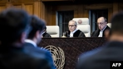 Presiding Judge Nawaf Salam, center, attends the International Court of Justice's ruling on Nicaragua's request for emergency measures to stop Germany from sending military supplies to Israel, in The Hague, Netherlands, on April 30, 2024.