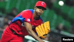 FILE - Cuba's Raciel Iglesias pitches a ball during the last preparation game for the World Baseball Classic (WBC) in Fukuoka, Japan, March 1, 2013. Iglesias failed to show up for training this week and was widely believed to have left the island.