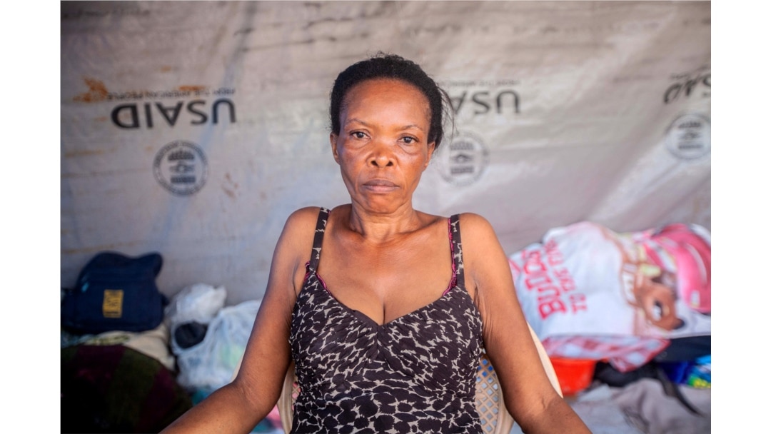 Vesta Guerrier, 48, poses for a portrait at a camp for people who lost their homes during the Aug. 14 earthquake, in Les Cayes, Haiti, Aug. 23, 2021.