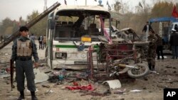 An Afghan policeman secures an area after a suicide vehicle bomb tore through the area on the outskirts of Kabul, Nov. 16, 2013. 