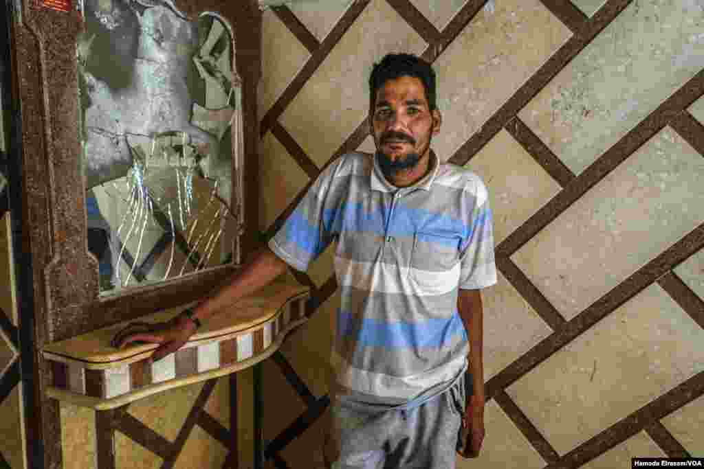 Saleh El-Asyouty, a 32-year-old resident of Alexandria, Egypt, says even though tourism has declined, rents continue to rise because buildings are being damaged by floods, heat and humidity. (Hamada Elrasam/VOA)