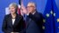 FILE - European Commission President Jean-Claude Juncker, right, greets British Prime Minister Theresa May at EU headquarters in Brussels, Nov. 21, 2018. 