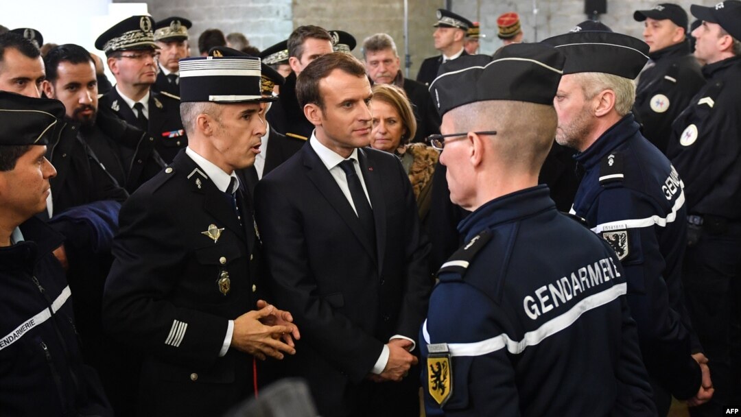 French President Emmanuel Macron, center, meets gendarmerie and police forces during his visit in the French northern city of Calais Jan. 16, 2018.