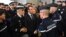 French President Emmanuel Macron, center, meets gendarmerie and police forces during his visit in the French northern city of Calais Jan. 16, 2018.