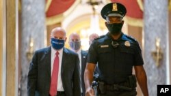 FILE - U.S. Postmaster General Louis DeJoy, left, is escorted to a meeting in House Speaker Nancy Pelosi's office on Capitol Hill in Washington, Aug. 5, 2020. 