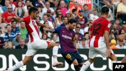 L'attaquant argentin de Barcelone, Lionel Messi (C), amorce un dribble face au défenseur espagnol de l'Athletic Bilbao Unai Nunez, à gauche, lors du match de football entre le FC Barcelone et l'Athletic Club Bilbao au stade Camp Nou de Barcelone le 29 sept