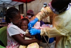 A child is vaccinated against Ebola in Beni, Congo, July 13, 2019.