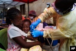 A child is vaccinated against Ebola in Beni, Congo, July 13, 2019.