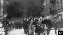 FILE - In this 1943 file photo, a group of Polish Jews are led away for deportation by German SS soldiers during the destruction of the Warsaw Ghetto by German troops after an uprising in the Jewish quarter.