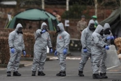 FILE - British detectives work the scene of a nerve-agent poisoning of Russian former double agent Sergei Skripal and his daughter, in Salisbury, Britain, March 14, 2018.