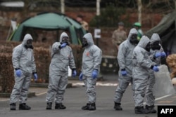 FILE - British detectives work the scene of a nerve-agent poisoning of Russian former double agent Sergei Skripal and his daughter, in Salisbury, Britain, March 14, 2018.