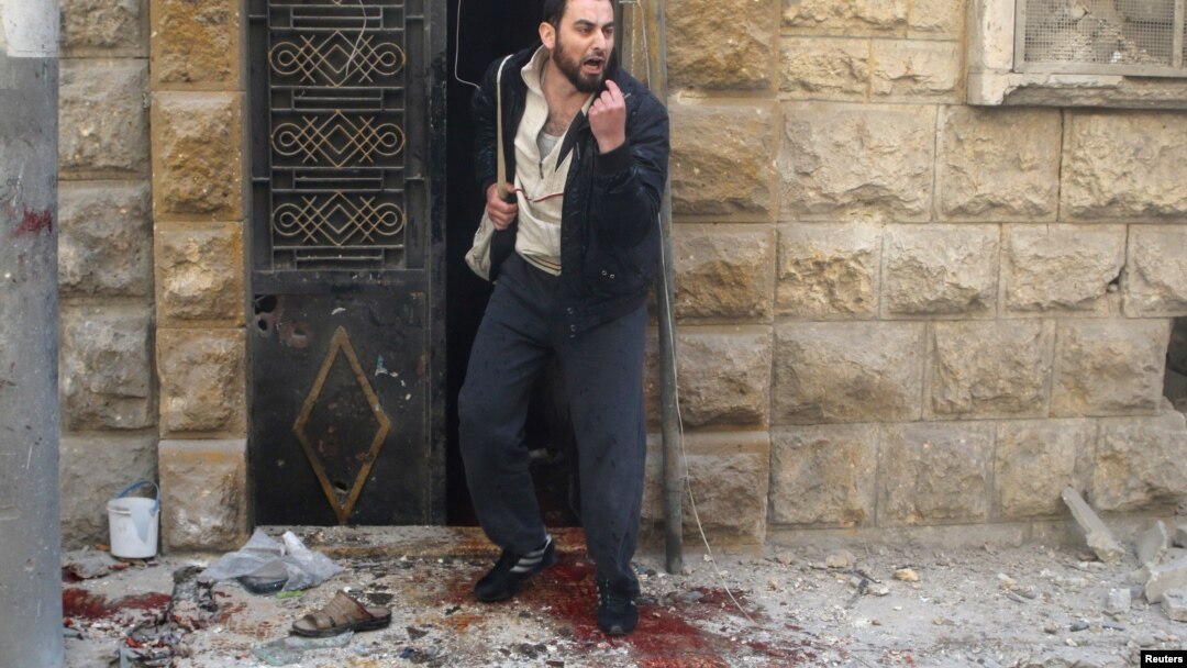 A man reacts as he stands on bloodstains at a site hit by airstrikes in the rebel-held area of Aleppo's al-Fardous district, Syria, April 29, 2016. 