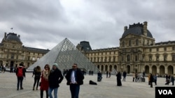Tourists visit the Louvre Museum in Paris, which reopened March 4, 2020, after being temporarily shut over staff coronavirus concerns. (Lisa Bryant/VOA)