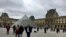 Tourists visit the Louvre Museum in Paris, which reopened March 4, 2020, after being temporarily shut over staff coronavirus concerns. (Lisa Bryant/VOA)