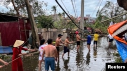 People remove fallen trees after Typhoon Yagi hit Hai Phong, Vietnam.