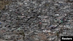 FILE - An aerial view of the ruins of houses after the devastation of super Typhoon Haiyan in Tacloban city in central Philippines, Nov. 11, 2013. 