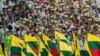 People wave the Myanmar national flag during a rally to show support to the Myanmar military in Yangon, May 5, 2019.