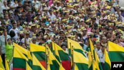 People wave the Myanmar national flag during a rally to show support to the Myanmar military in Yangon, May 5, 2019.