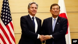 (FILE) U.S. Secretary of State Antony Blinken shakes hands with Japanese Prime Minister Shigeru Ishiba in Tokyo Tuesday, Jan. 7, 2025.