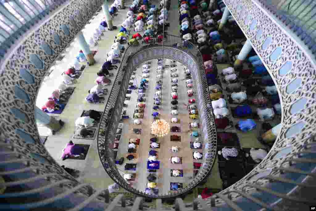 Bangladeshi Muslims offer Eid al-Fitr prayers, marking the end of the holy month of Ramadan, inside the Baitul Mukarram Mosque in Dhaka, Bangladesh.