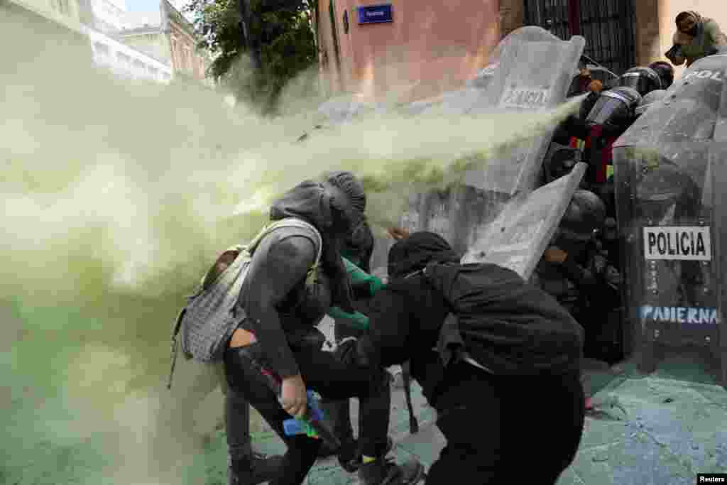Members of a feminist collective clash with police officers during a march to mark the International Safe Abortion Day in Mexico City, Mexico, Sept. 27, 2020.