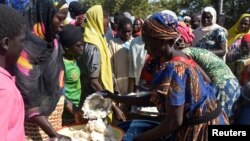  Cameroonians who fled deadly intercommunal violence between herders and farmers get food at a temporarily refugee camp on the outskirts of Ndjamena, Chad, Dec. 13, 2021. 