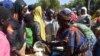 FILE - Cameroonians who fled deadly intercommunal violence between herders and farmers get food at a temporarily refugee camp on the outskirts of Ndjamena, Chad, Dec. 13, 2021. 