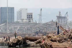 People are pictured at the site of the explosion at the port of Beirut, Lebanon, Aug. 6, 2020.