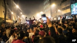 FILE - People celebrate Morocco's win over Spain in a World Cup match played in Qatar, in Rabat, Morocco, Tuesday, 6, Dec., 2022. 