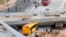 Rescue workers try to reach vehicles trapped underneath an overpass bridge that collapsed while under construction in Belo Horizonte, Brazil, July 3, 2014.